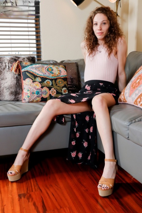 Curly-haired shemale Belle Adams doffs her clothes & teases with her hot dick