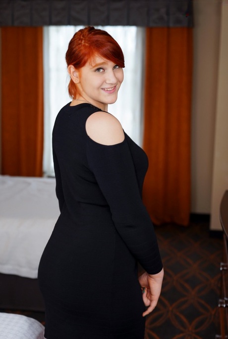 Redheaded shemale fatty Ashlee Alespia strips & shows her big ass & tiny dick