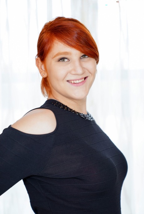 Redheaded shemale fatty Ashlee Alespia strips & shows her big ass & tiny dick