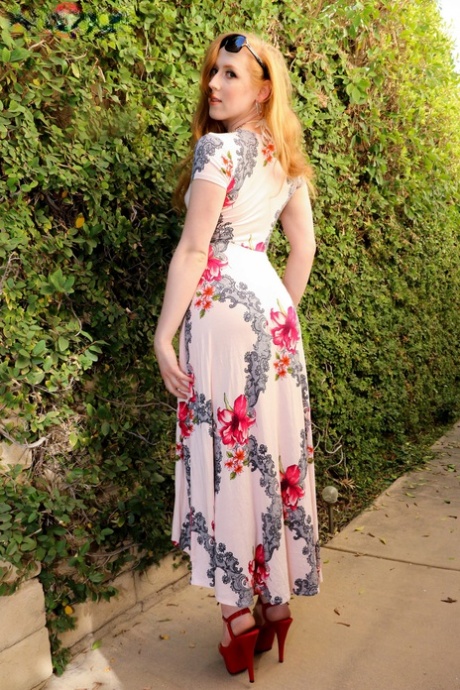 Redheaded shemale Shiri Allwood strips her dress & shows her big ass & cock