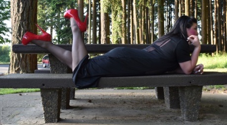 Naughty shemale teases in see-through dresses & high heels outdoors