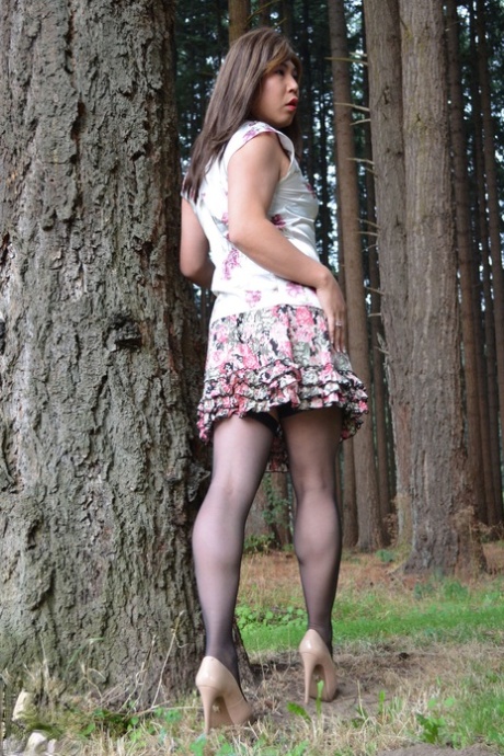 Bootylicious Asian shemale masturbating in the park near the roadway