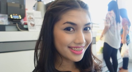 Stunning Asian shemale Wine poses seductively at the restaurant