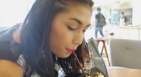 Stunning Asian shemale Wine poses seductively at the restaurant