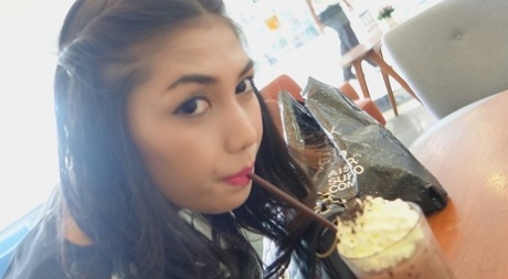 Stunning Asian shemale Wine poses seductively at the restaurant