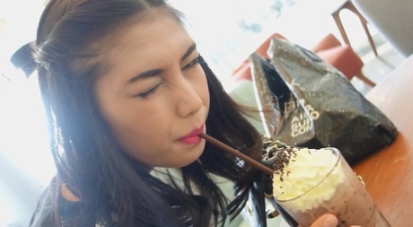 Stunning Asian shemale Wine poses seductively at the restaurant
