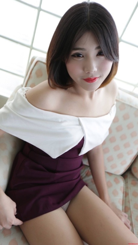 Brunette Asian shemale exposes her tiny tits and poses in undies