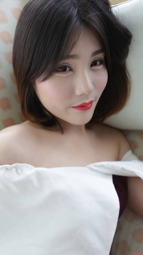 Brunette Asian shemale exposes her tiny tits and poses in undies