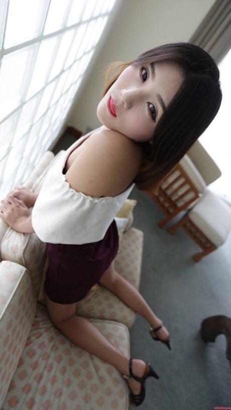 Brunette Asian shemale exposes her tiny tits and poses in undies