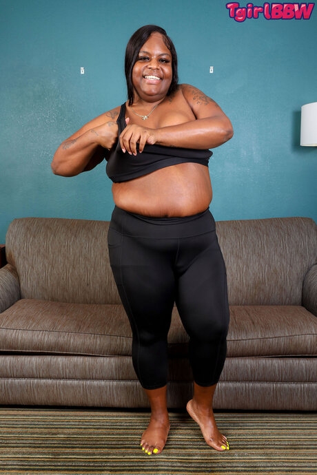 Ebony shemale removes her tights and reveals her dick and huge ass