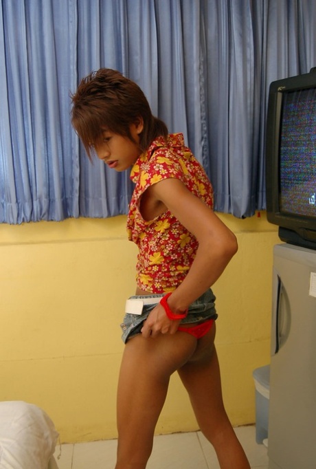 Petite Asian shemale Ment undresses to show her unaroused small dick